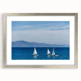 Textured art depicting abstract ocean waves in muted blue and green hues, framed with a silver mat.