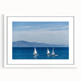 Abstract art print featuring a muted palette of blue and gray, framed in white, ideal for bedroom or dining room decor.