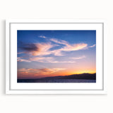 Abstract art print of Santa Monica scenery in muted blue and beige tones, framed in white, ideal for dining room decor.