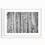 Abstract art print of a mountain scenery in cool blue and white, framed with a white mat, suitable for dining room decor.