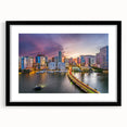 Abstract art print of Miami skyline in vibrant colors on a large, textured canvas, framed in black.