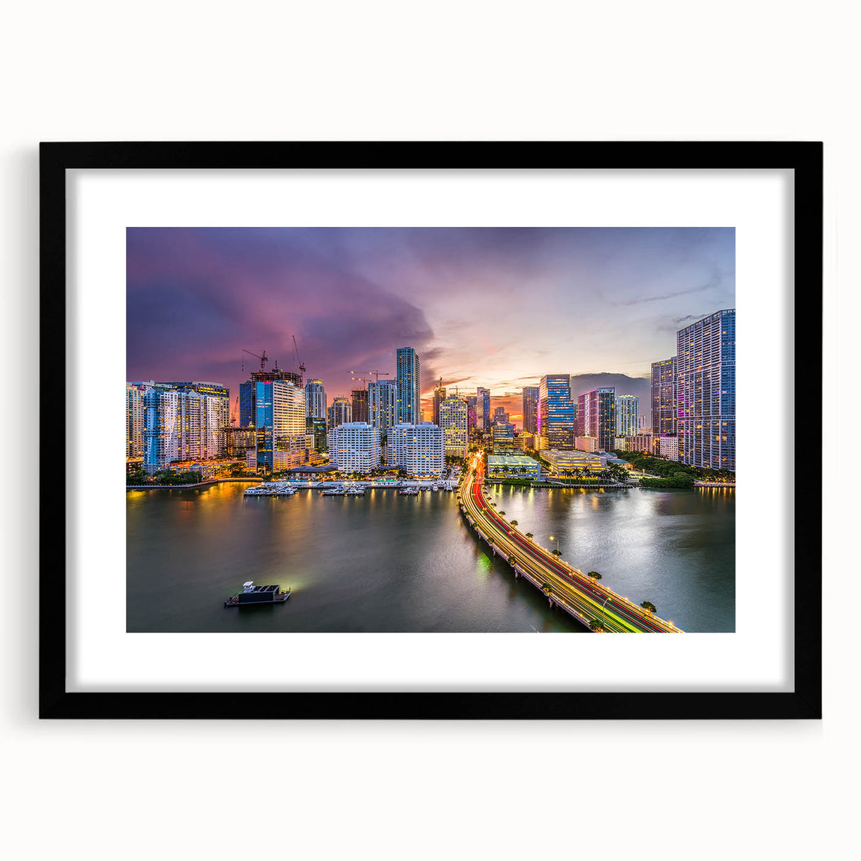 Abstract art print of Miami skyline in vibrant colors on a large, textured canvas, framed in black.
