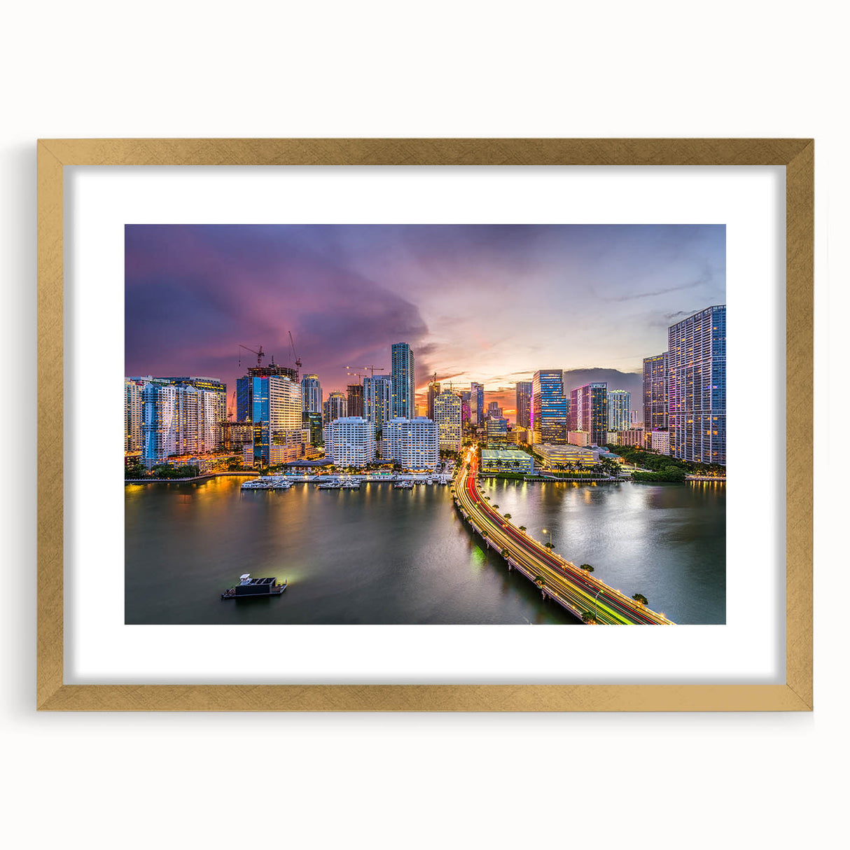 Extra large abstract art print of Miami skyline in vibrant sunset hues, framed in gold, ideal for living room decor.