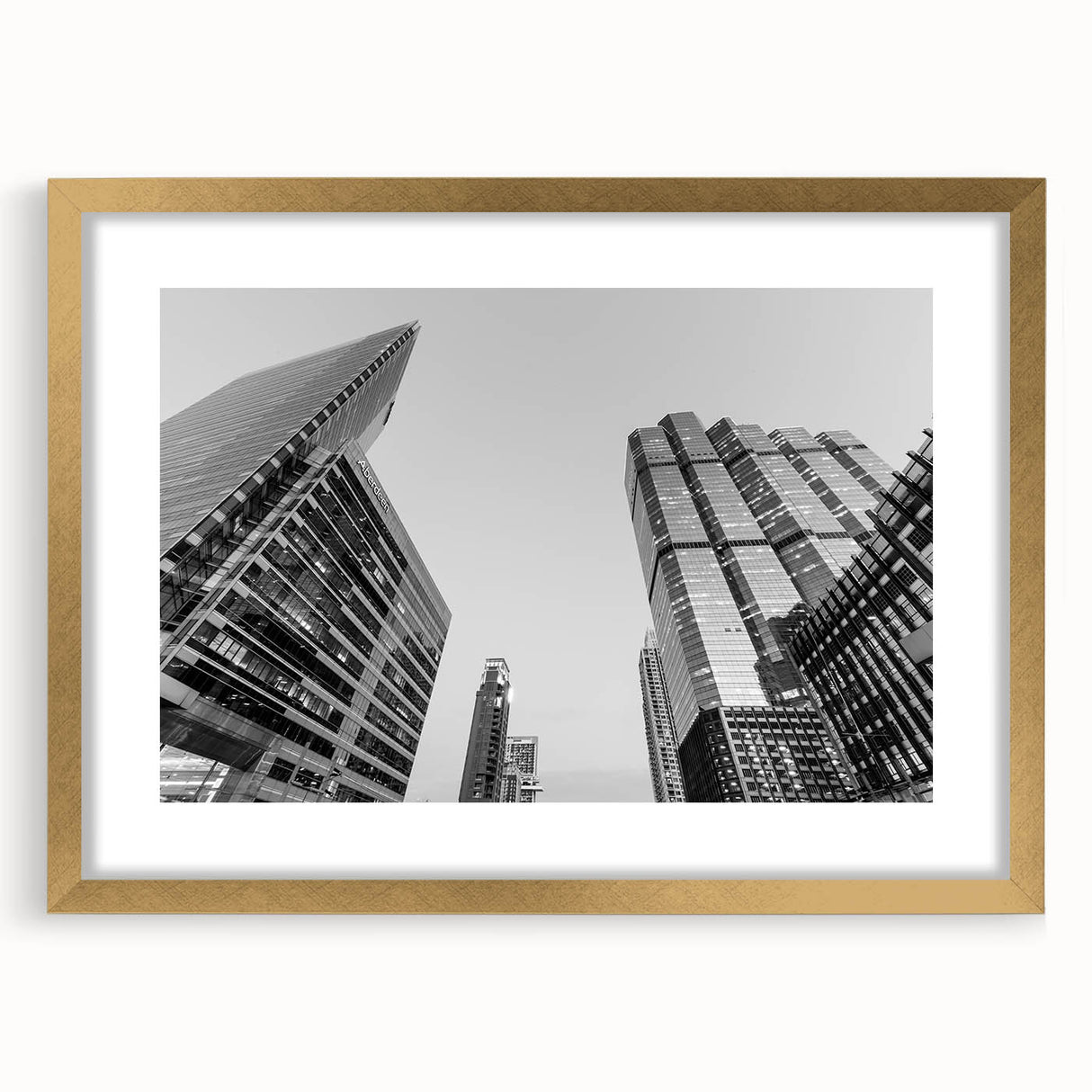 Extra large abstract art print of Atlanta skyline in muted grays and blues, framed in gold, ideal for living room decor.