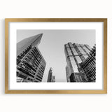 Extra large abstract art print of Atlanta skyline in muted grays and blues, framed in gold, ideal for living room decor.