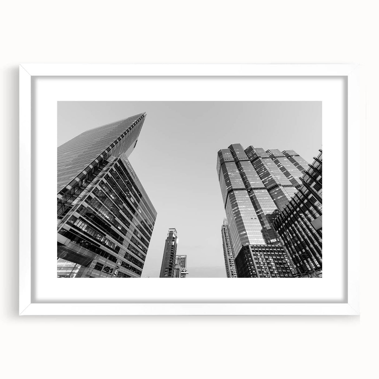 Abstract art print of Atlanta skyline in muted gray and blue tones on a framed white canvas.