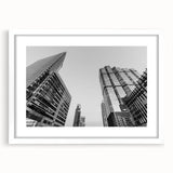 Abstract art print of Atlanta skyline in muted gray and blue tones on a framed white canvas.