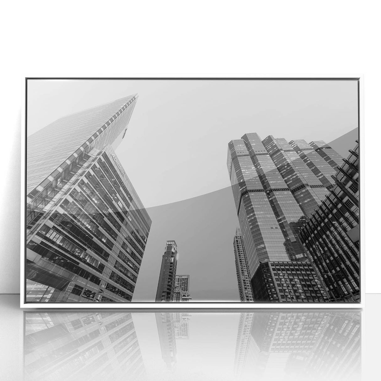 Art deco poster of Atlanta skyline in muted gray and blue tones, acrylic print framed in white.