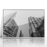 Art deco poster of Atlanta skyline in muted gray and blue tones, acrylic print framed in white.