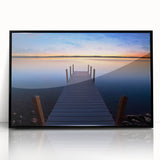 Large abstract wall art of Lake Michigan with muted blue and gray tones on a black framed acrylic.