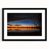 Abstract art print featuring vibrant, colorful textures, framed in black, ideal for living room decor.