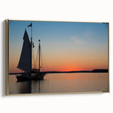 Framed canvas featuring a landscape painting of Maine's coastline in muted gold and black tones.