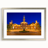 Textured abstract art print of Baltimore skyline with muted gray and blue tones, framed in silver, ideal for bedroom art.