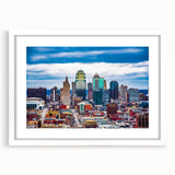 Abstract art print of Kansas City skyline in muted gray and blue tones on a framed white mat, ideal for dining room decor.