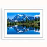 Abstract art print depicting Glacier National Park in muted blue and green tones, framed with a white mat.