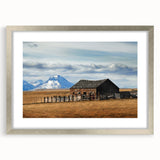 Textured art featuring abstract Montana scenery in earthy tones on a silver-framed mat, ideal for bedroom ambiance.