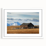 Abstract art print of Montana scenery in muted earth tones on a white framed mat, suitable for dining room decor.