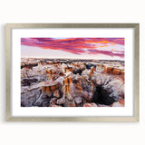 Textured abstract art print depicting a New Mexico landscape in earth tones, framed in silver, suitable for bedroom decor.