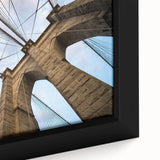 Close-up of a framed canvas depicting the Brooklyn Bridge in black with colorful, textured art accents.