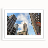 Abstract art print of NYC skyline in muted gray and blue tones on a white framed poster, ideal for dining room decor.