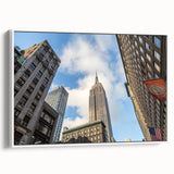 Vintage poster art of NYC Empire State Building in colorful tones on a framed canvas, ideal for living room decor.