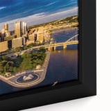 Black wall art featuring a textured depiction of Pittsburgh's skyline in colorful hues on a framed canvas.