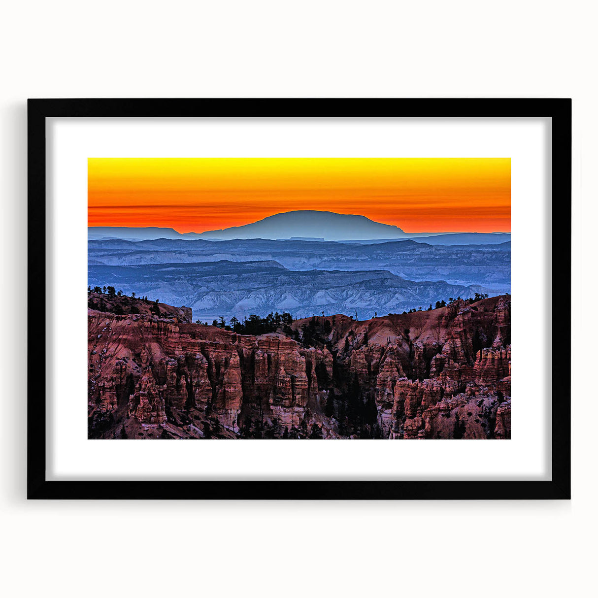 Colorful abstract art print of Bryce Canyon in vibrant orange and red hues on a large textured canvas.