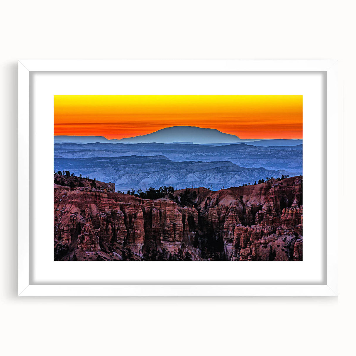 Abstract art print of Bryce Canyon in muted orange and red tones on a framed white mat, ideal for dining room decor.
