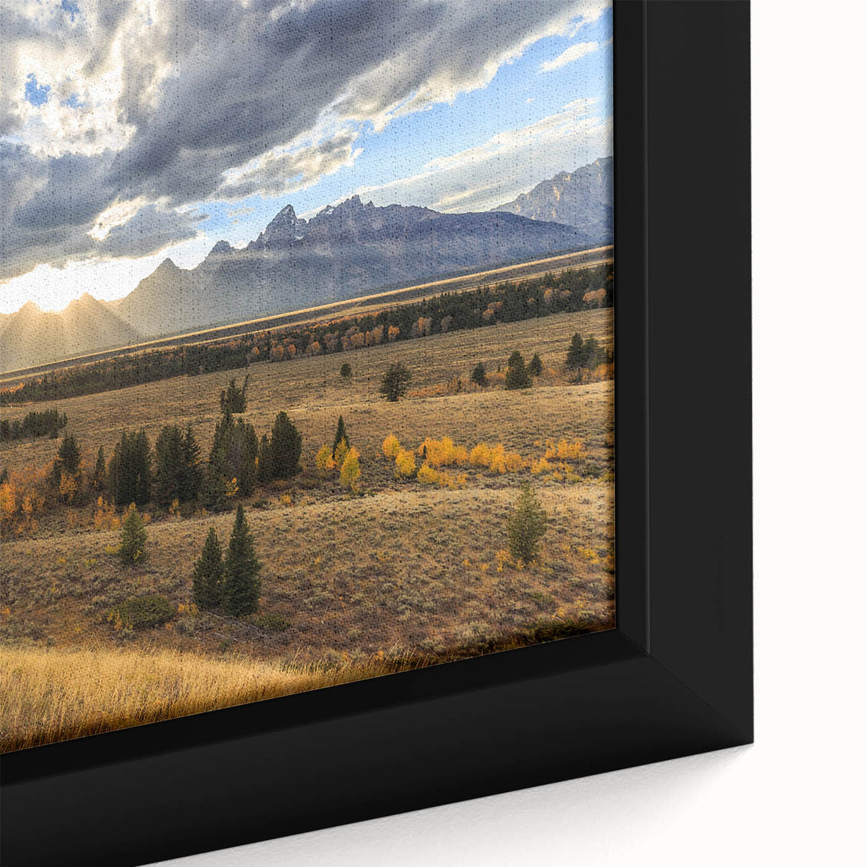 Close-up of textured black wall art depicting the Grand Tetons, with vibrant color accents, framed canvas.