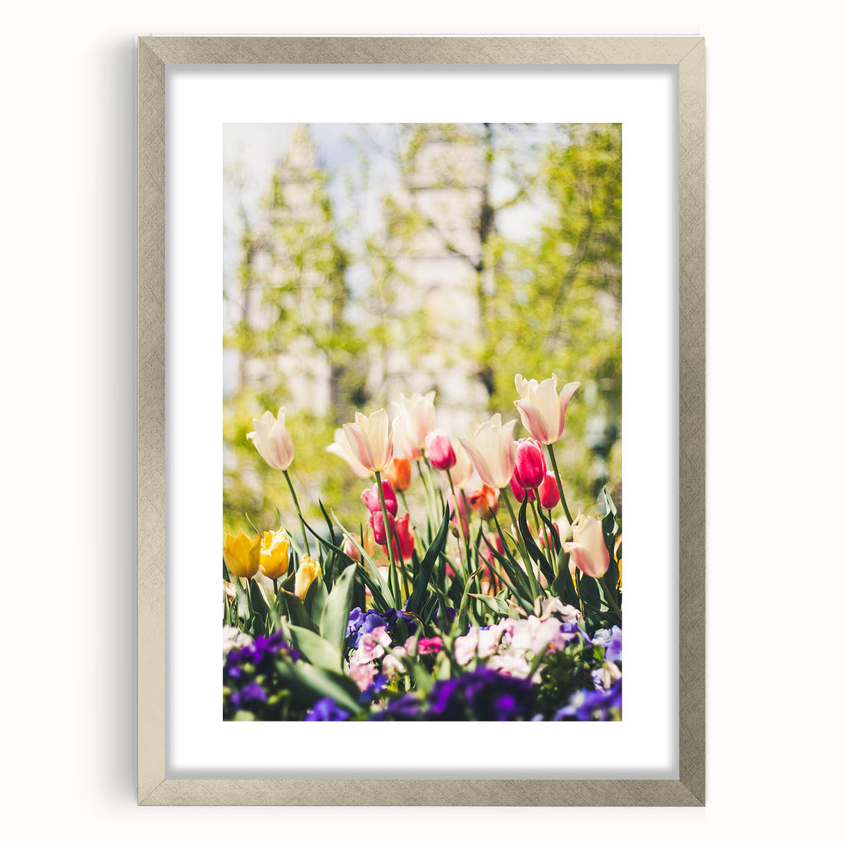 Textured art print of abstract spring-themed design in pastel shades, framed in silver, suitable for bedroom decor.