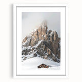 Abstract art print of winter scene with muted blue and white tones on a framed white mat, ideal for dining room decor.