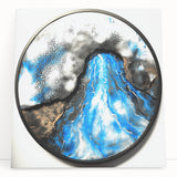 Abstract geometric stretched canvas artwork showcasing vibrant blue, orange, and yellow shapes, leaning against a minimalist wall, perfect for modern decor.