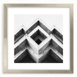 Textured abstract art print in silver frame, featuring undulating gray patterns, ideal for modern bedroom decor.