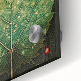 Close-up of vibrant acrylic wall art showcasing intricate floral and botanical designs, featuring lush green leaves and colorful flowers on a glass surface, ideal for home decor.