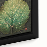 Close-up of a framed canvas wall art depicting vibrant floral and botanical leaves, showcasing intricate details and rich colors, perfect for home decor.