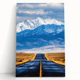 Stretched canvas artwork depicting a vibrant African landscape scene, featuring rich colors and textures, leaning against a neutral wall, ideal for home decor.