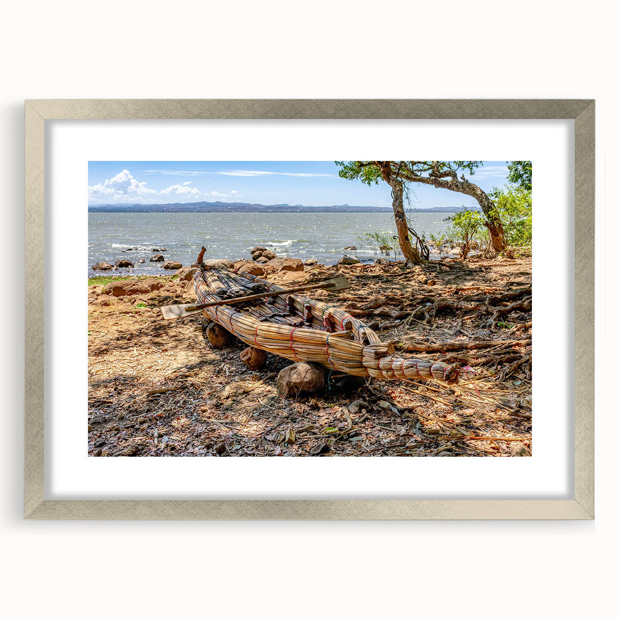 Abstract art print of an Ethiopian landscape in muted earth tones on a framed silver matte, suitable for dining room decor.