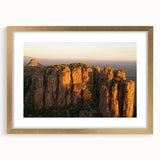 Extra large abstract art print depicting a textured African scenery in gold and earth tones, framed with a mat.