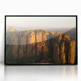 Large abstract wall art of an African scenery in muted earth tones on a framed acrylic.