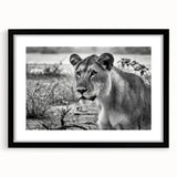 Extra large colorful art print depicting an abstract African scenery in vibrant hues on textured canvas, framed in black.