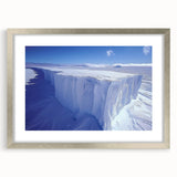 Textured abstract art print depicting an Antarctic landscape in muted blue and white tones, framed in silver.