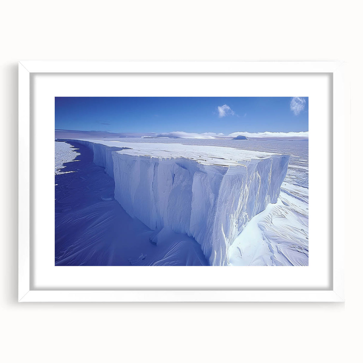 Abstract art print depicting an Antarctic landscape in muted blue and white tones, framed with a white mat.