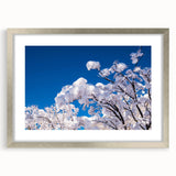 Abstract textured art print featuring swirling gray and blue tones on a framed silver mat, ideal for bedroom decor.