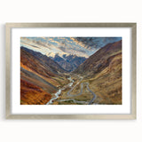 Textured art print of abstract scenery in muted earth tones on a silver-framed canvas, ideal for bedroom decor.