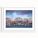Abstract art print of Newfoundland scenery in muted blue and green tones, framed with a white mat.