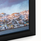 Close-up of a textured black wall art depicting a colorful Newfoundland scenery on a framed canvas.