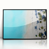 Large abstract wall art depicting Caribbean scenery in muted blue and green tones, framed in black acrylic.