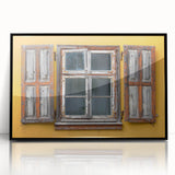 Large abstract wall art depicting a Caribbean scenery in muted blue and green, framed in black acrylic.