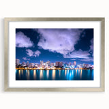 Extra large abstract art print of a Caribbean scenery in muted blue and green tones, framed in silver.