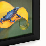 Close-up of textured black wall art featuring a colorful Central American scenery on a framed canvas.